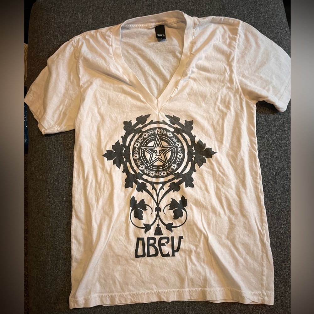 Women’s white deep V Obey shirt.